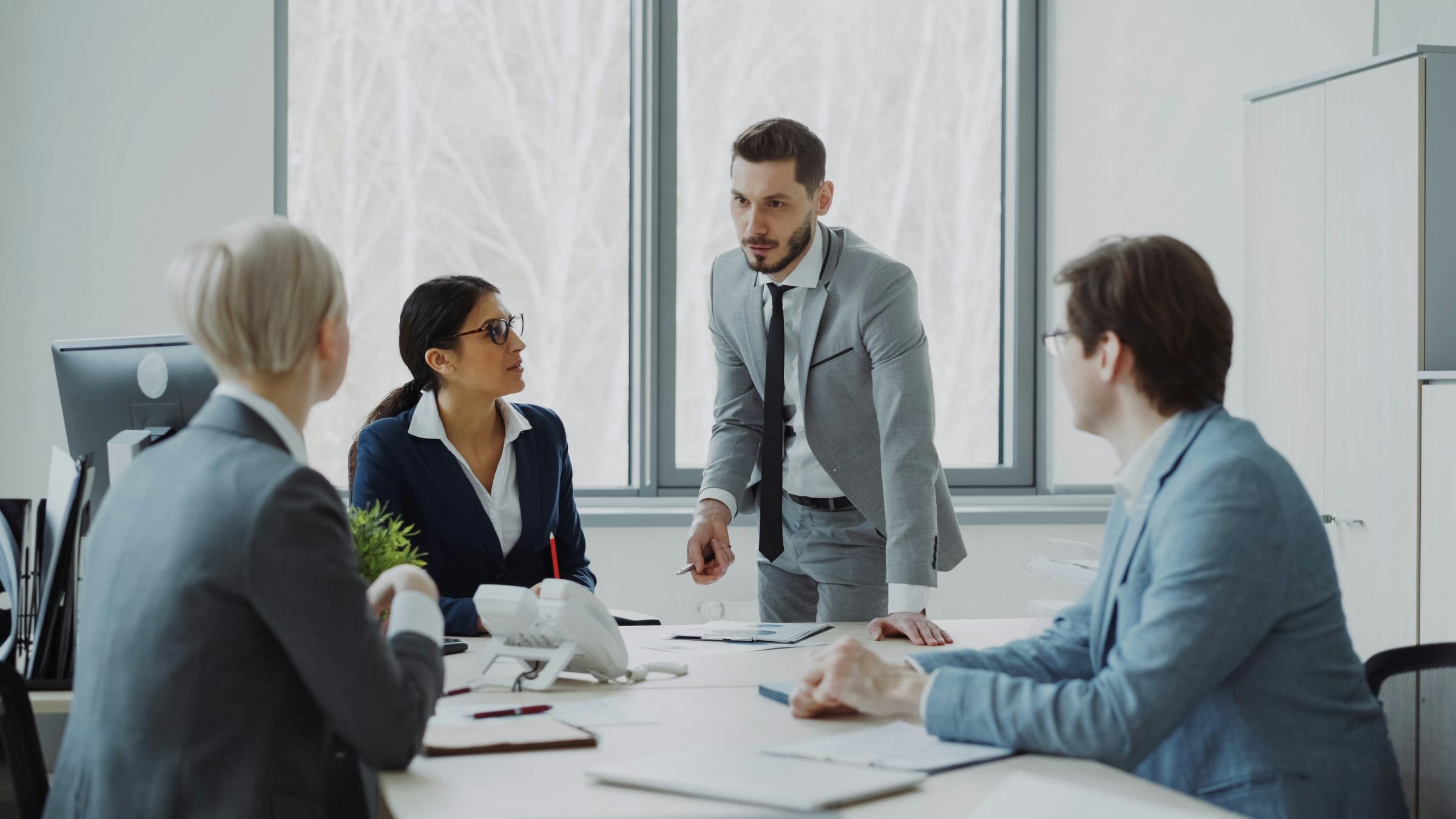 A consulting team working through a business review around a boardroom table